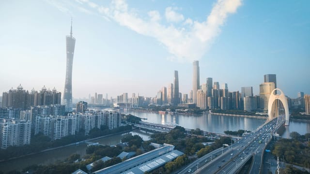 Panoramic aerial shot of Guangzhou skyline with Canton Tower and modern architecture.