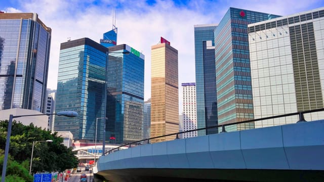 Stunning view of Hong Kong's vibrant skyscrapers and urban architecture under a blue sky.
