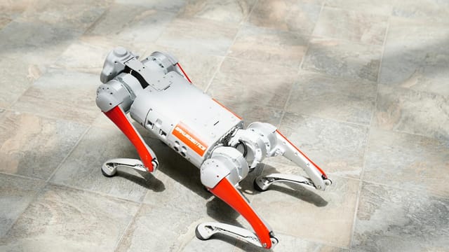 High-tech robotic dog on a tiled surface, showcasing cutting-edge robotics.
