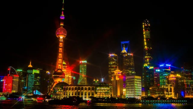 Stunning illuminated skyline of Shanghai featuring the Oriental Pearl Tower at night.