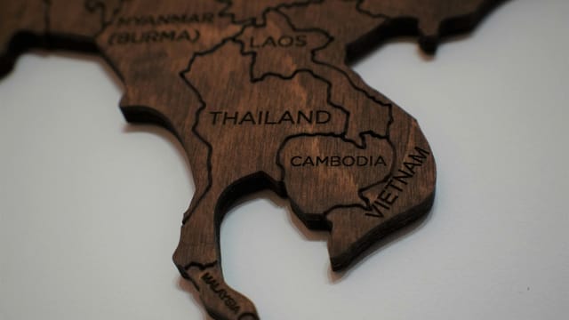 Intricate wooden map piece featuring Southeast Asia with country names engraved.