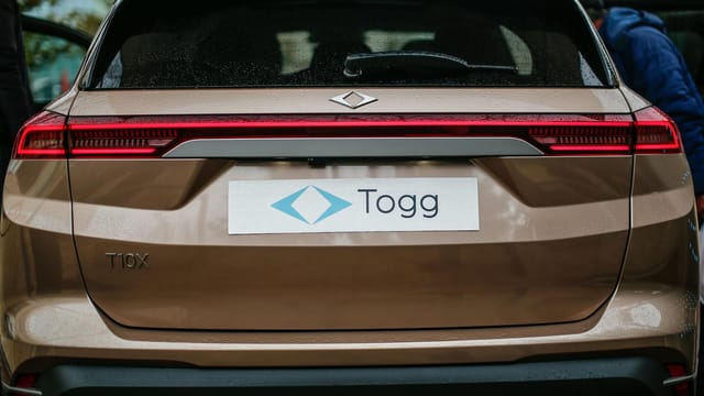 Rear view of a brown TOGG T10X electric SUV in Malatya, Türkiye, showcasing modern design.