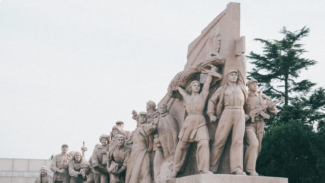 Majestic stone statues depicting historical figures in Beijing, China.