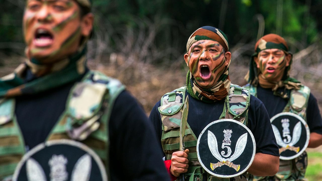 Military soldiers shouting commands in camouflage uniforms during an outdoor training drill.
