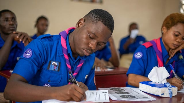 Dedicated group of youth scouts actively engaged in educational activities in a classroom.