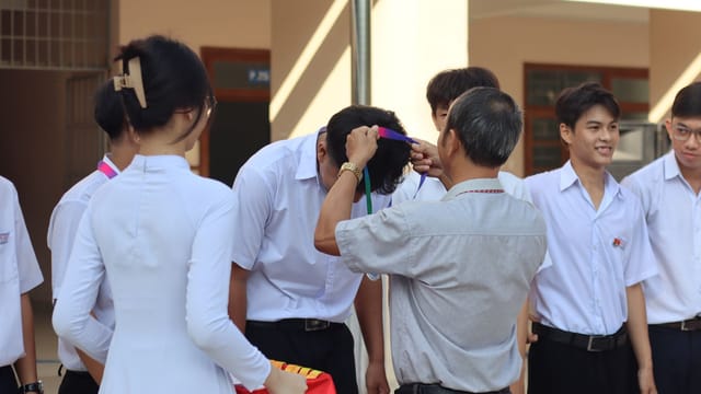 Students receiving awards at a school ceremony, capturing a moment of celebration and achievement.