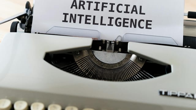 A close-up of a typewriter showcasing 'ARTIFICIAL INTELLIGENCE' on paper.