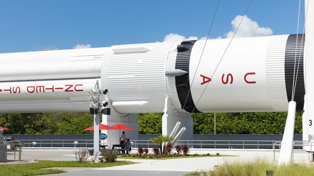 A detailed view of a rocket at Cape Canaveral's Kennedy Space Center with clear skies.