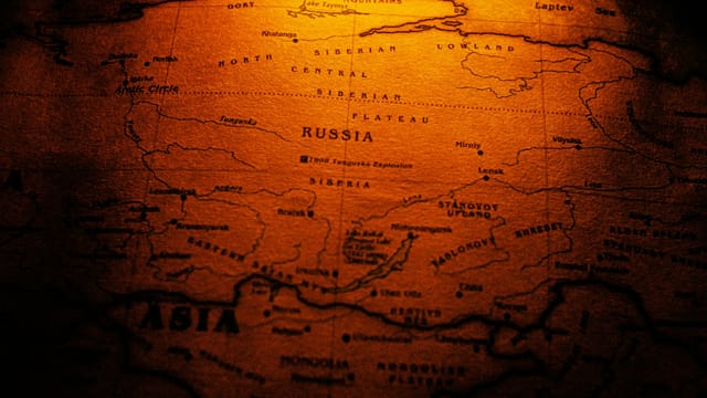 Close-up of a sepia toned vintage map highlighting Russia and Siberia.