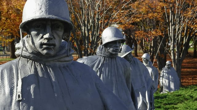 Statues of soldiers at the Korean War Veterans Memorial in autumn.