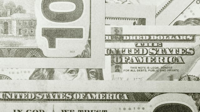 Detailed close-up of United States dollar bills in a monochrome filter, captured in Berlin.