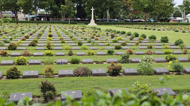A tranquil view of war graves in Kanchanaburi's beautifully landscaped cemetery.