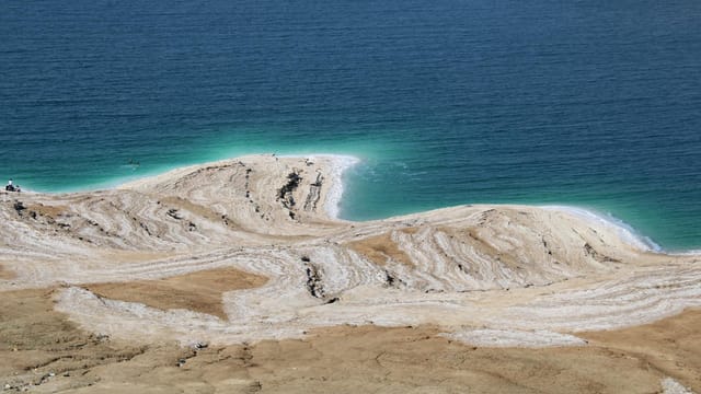 A striking aerial view of the Dead Sea's salt formations and blue waters.