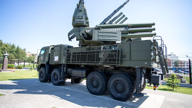 Outdoor display of a military missile defense system on a sunny day, highlighting its structure.