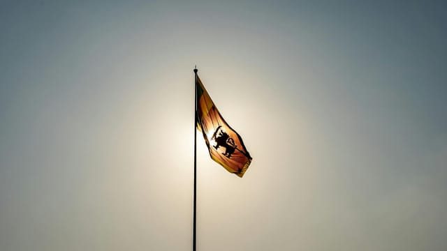 Sri Lankan flag waving against a clear sky in Colombo, symbolizing national pride.