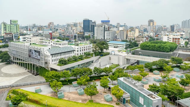 Aerial view of Gwangju cityscape showcasing modern architecture and green spaces.