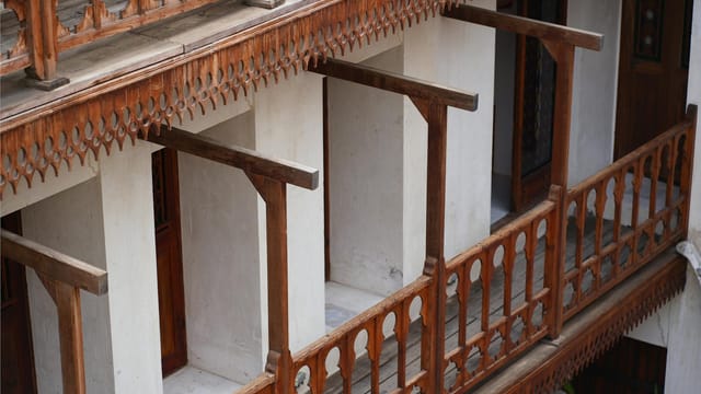 Close-up of wooden railings and balconies showcasing vintage Iranian architecture style.