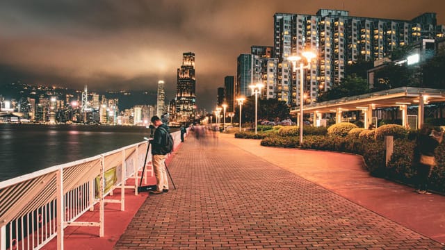 Explore the illuminated Hong Kong skyline from the vibrant Hung Hom Promenade at night.