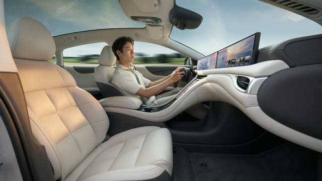 A modern electric car interior showcasing advanced technology with a driver enjoying a smooth ride.