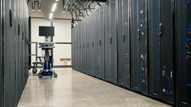 Steel framework cabinets housing servers networking devices and cables in contemporary equipped data center