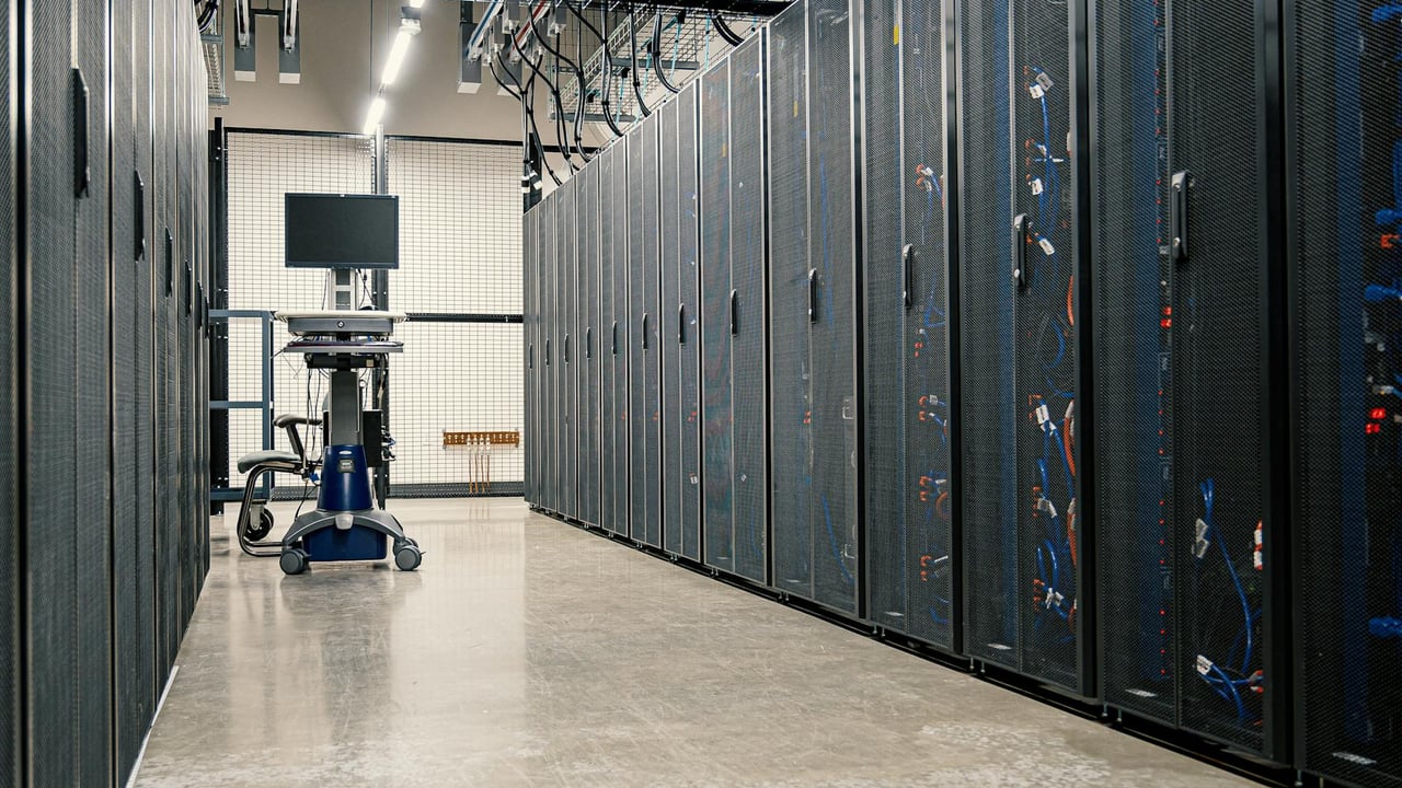 Steel framework cabinets housing servers networking devices and cables in contemporary equipped data center