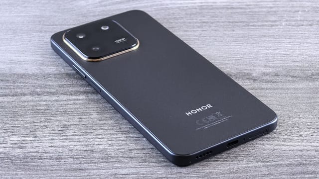 Close-up of a modern smartphone with a sleek design on a wooden surface.