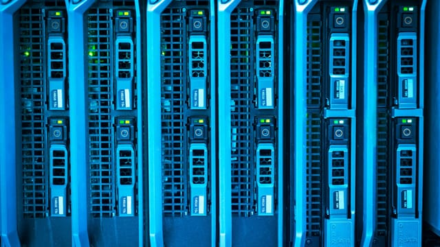 Detailed image of illuminated server racks showcasing modern technology infrastructure.