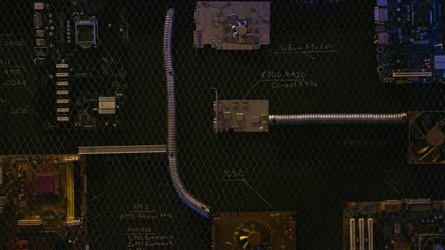 Artistic arrangement of circuit boards and cables symbolizes modern technology.