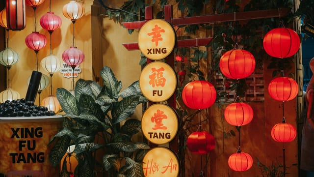 Traditional Asian lanterns illuminating the night street in Hoi An, creating a warm and cultural ambiance.