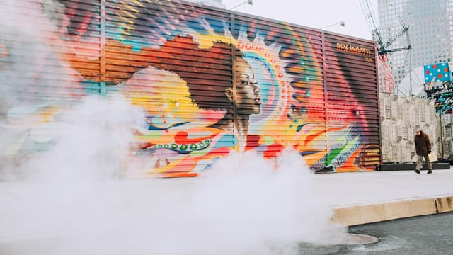 Dynamic street art mural in New York City with vibrant colors and urban atmosphere.