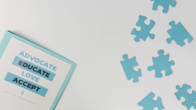 Blue puzzle pieces with advocacy messages for autism awareness.
