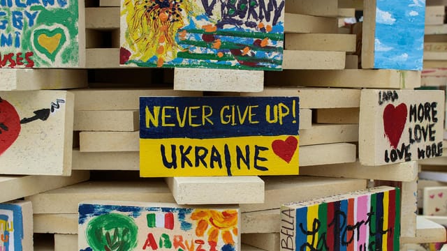 Vibrant painted bricks with supportive messages for Ukraine showcasing unity and hope.