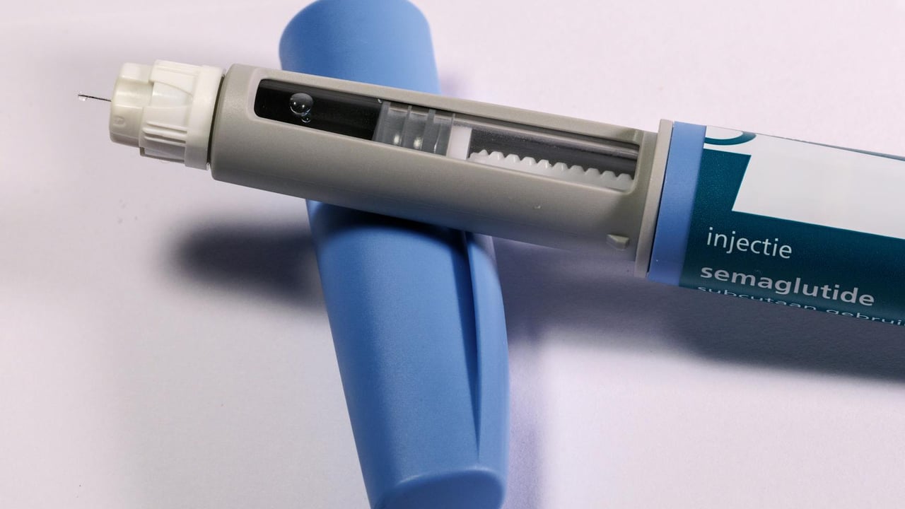 Detailed view of a semaglutide injection pen, commonly used for diabetes treatment, on a plain background.