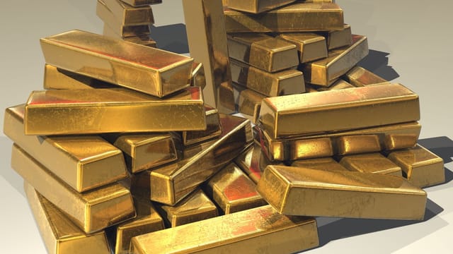 A pile of lustrous gold bars symbolizing wealth and prosperity.