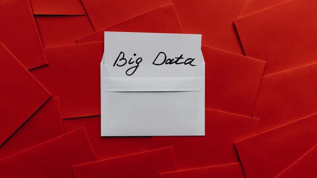 White envelope with 'Big Data' text on red envelope background. Conceptual digital imagery.