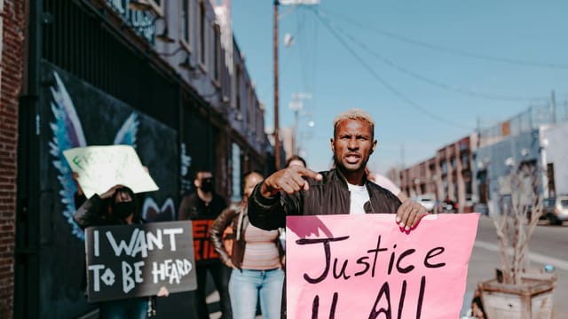 A group of activists holding signs demanding justice during a peaceful protest in the city.