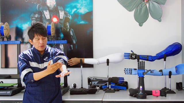 Bolivian robotics developer Roly Ronald Mamani demonstrating a bionic prosthetic arm