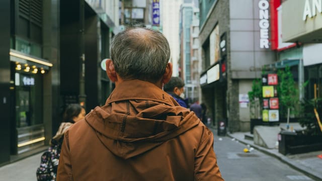 Vibrant street scene in Seoul, South Korea with pedestrians walking among modern architecture.