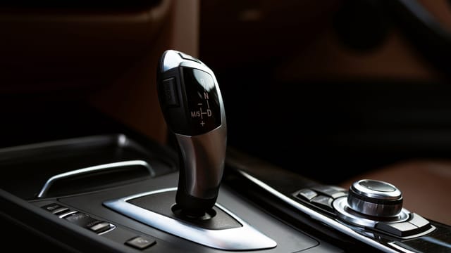 Close-up of a modern automotive gear shifter, highlighting contemporary design.