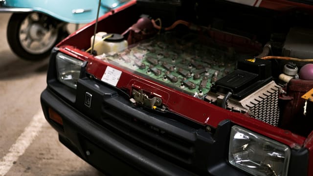 Detailed close-up of a car engine under the hood showcasing various components and connections.