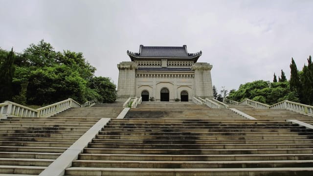 Majestic view of Dr. Sun Yat-sen's Mausoleum surrounded by greenery in Nanjing.