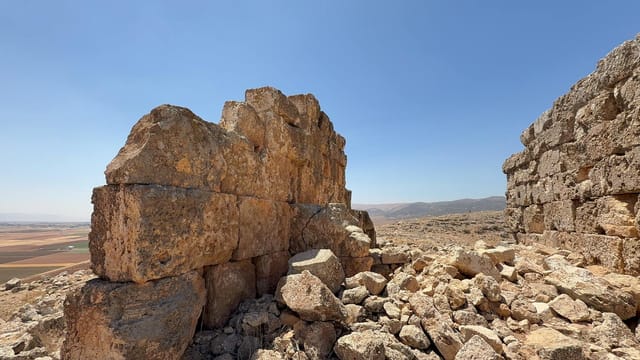 Rugged ancient stone ruins with a breathtaking clear sky backdrop.