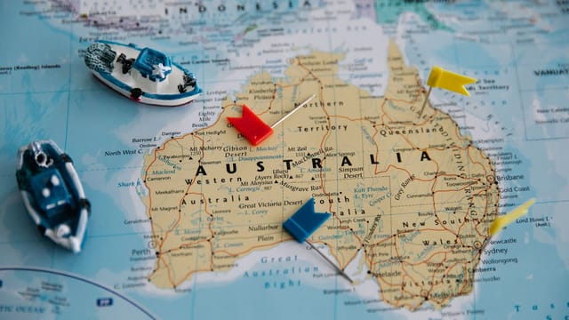 Colorful map of Australia featuring toy ships and pins for navigation.