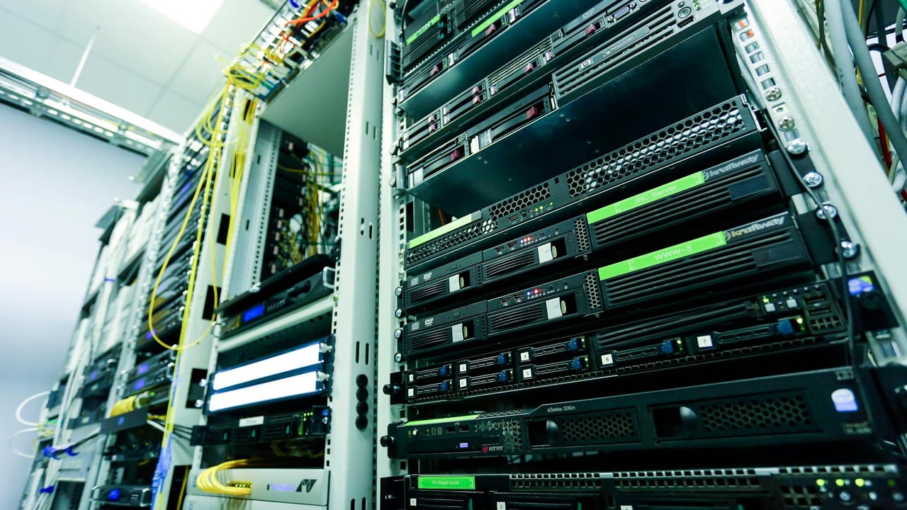High-tech server rack in a secure data center with network cables and hardware components.