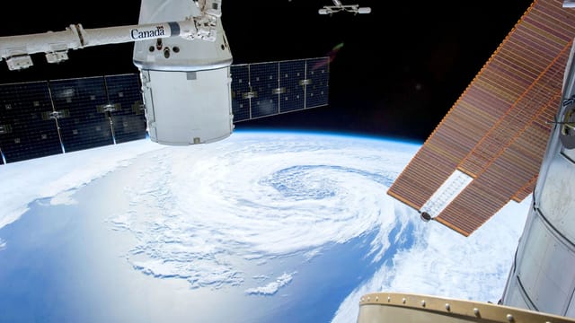 A mesmerizing view of Earth as seen from a space station with solar panels and satellite modules.