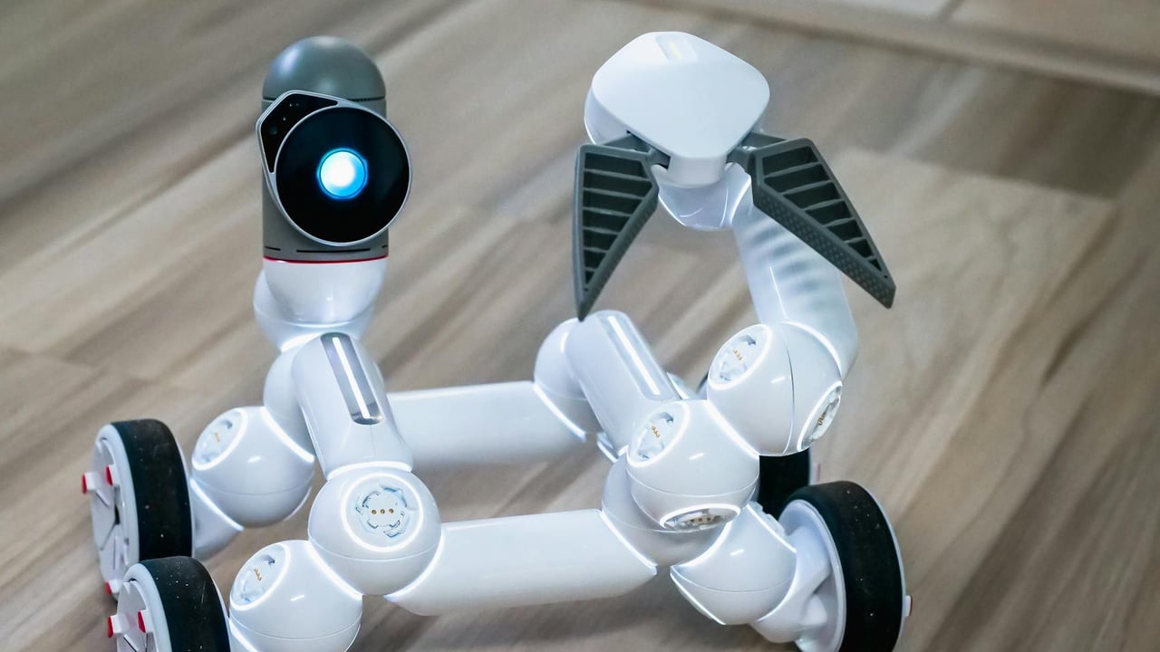 Close-up of a modern wheeled robot with a blurred background, indoors.