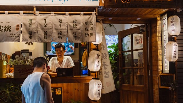 A charming Chinese tea shop with lanterns and traditional decor, exuding warmth and hospitality.