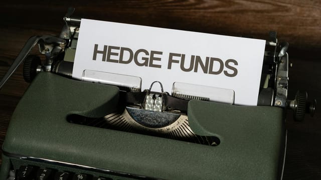 Close-up of a vintage typewriter with a paper labeled 'Hedge Funds'.