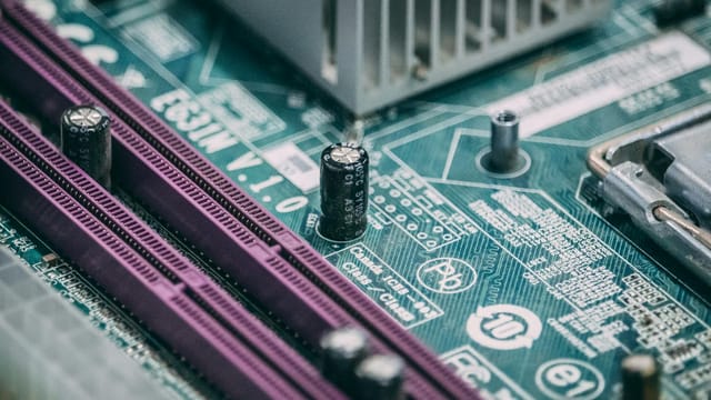 Detailed close-up image of a computer circuit board with capacitors and other components.