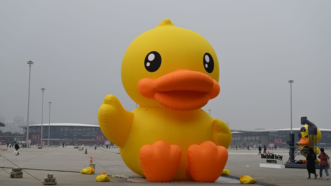 Large yellow inflatable duck at an outdoor event showcasing fun and creativity.